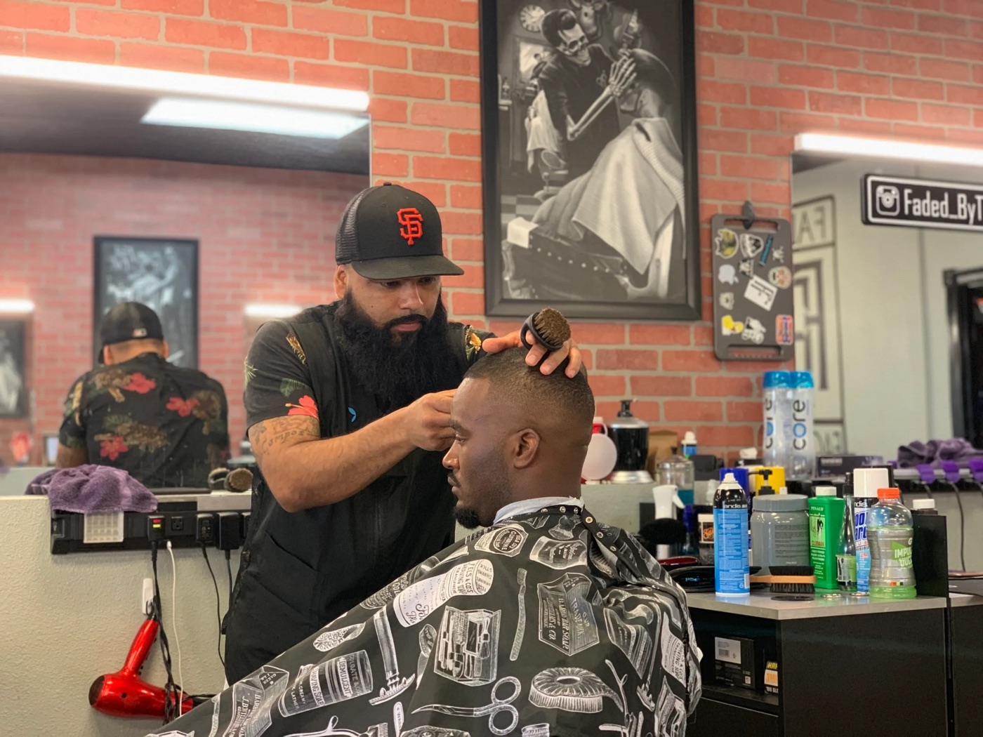 Guillermo G finishing up a client's fade at the shop