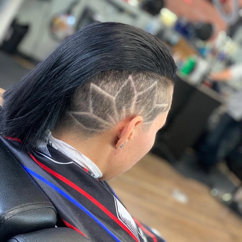 Slicked-back undercut with lotus design